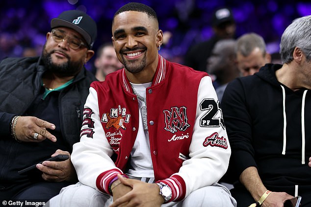 The Eagles quarterback watches as Jalen Hurts attends the Lakers-Sixers game in Philadelphia