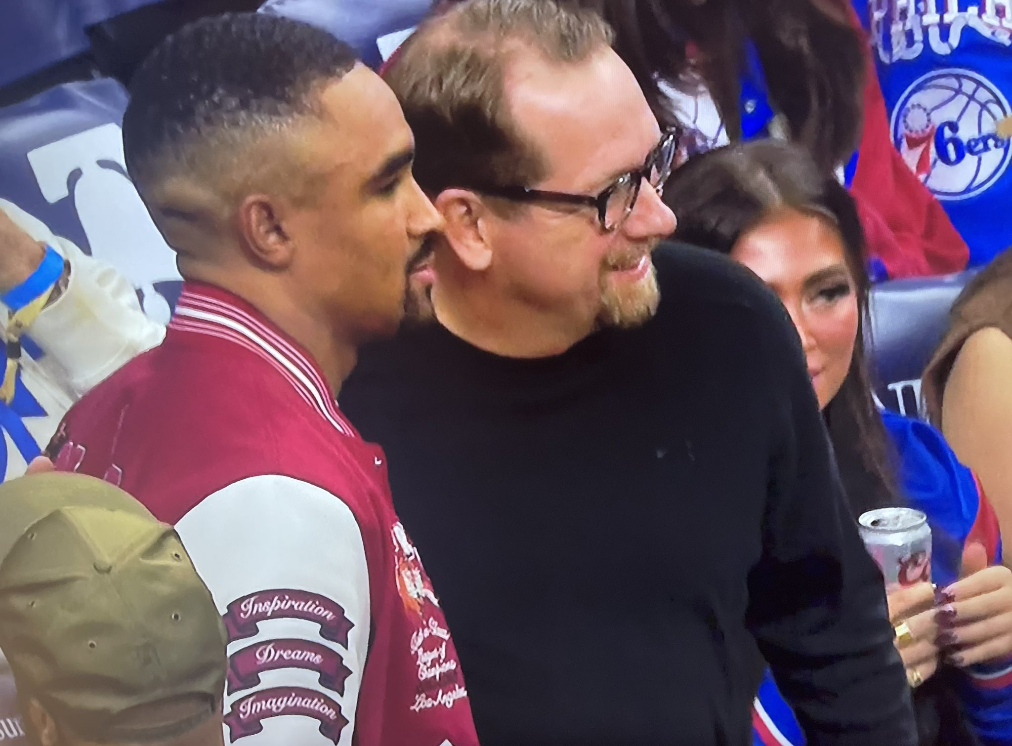 The Eagles quarterback watches as Jalen Hurts attends the Lakers-Sixers game in Philadelphia