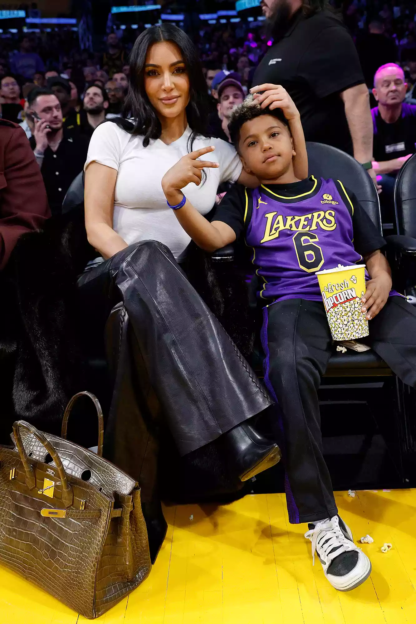 Kim Kardashian and Saint West attend a basketball game between the Los Angeles Lakers and Golden State Warriors at Crypto.com Arena on March 16, 2024 in Los Angeles, California.