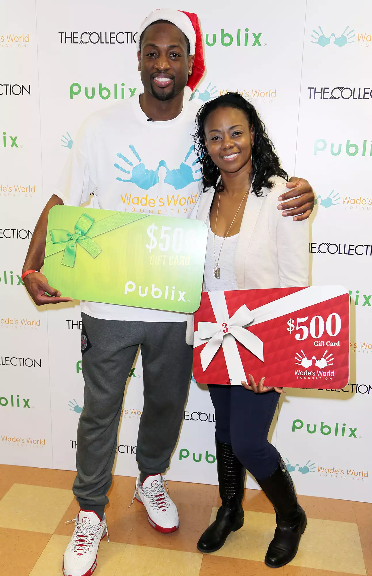 Dwyane Wade and Tragil Wade attend Publix Supermarket where Wade's World Foundation granted the wishes of deserving families on December 22, 2013.